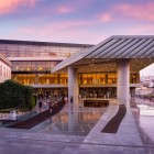 The entrance to the New Acropolis Museum welcomes visitors with contemporary architecture that blends seamlessly with the timeless heritage of ancient Athens.