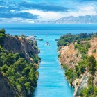 The Corinth Canal links the Ionian Sea with the Aegean through a spectacular rock-cut gorge. An engineering masterpiece that continues to amaze visitors today.
