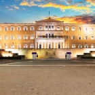 The Hellenic Parliament lights up Syntagma Square, the heart of Greece's political life. Here, history meets the present beside the Evzones and the Tomb of the Unknown Soldier.