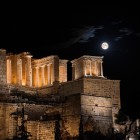 The Temple of Athena Nike and the Propylaea illuminate the entrance to the Acropolis. As night falls, they reveal the timeless grandeur of ancient Athens.