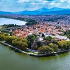 Aerial view of Ioannina's historic peninsula, surrounded by the waters of Lake Pamvotida. Ancient walls, the castle and lush greenery create one of Epirus' most captivating landscapes.
