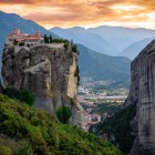 Perched atop the cliffs of Meteora above Kalambaka, the Holy Trinity Monastery offers one of Greece's most breathtaking sunset views, a UNESCO World Heritage Site.