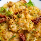 The tapa, a symbol of Cadiz cuisine, combines fried shrimp and vegetables to showcase the city's authentic flavours, best enjoyed in its traditional old-town taverns.