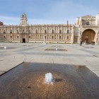 A fountain in the foreground brings life to León's Plaza de San Marcos, with the magnificent Renaissance monastery rising in the background, a landmark of the Camino de Santiago.