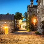 The ancient stone houses of O Cebreiro glow at dusk, creating a warm and peaceful atmosphere in the first Galician village along the Camino de Santiago.