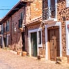 Stone houses line the historic cobbled street of Castrillo de los Polvazares, preserving the timeless charm of this village along the Camino de Santiago.