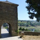 The ancient Pilgrims' Gate welcomes travellers to Portomarín, opening onto views of the Miño River and the route leading towards Santiago de Compostela.