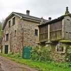 A traditional Galician stone house with its iconic hórreo, the region's raised granary, welcomes pilgrims along the Camino de Santiago, preserving centuries of rural heritage.