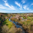 The Furelos River flows through Melide, a Galician town of around 7,200 inhabitants, along the Camino de Santiago, surrounded by green landscapes and traditional stone houses.