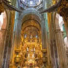 The High Altar of the Cathedral of Santiago de Compostela captivates with its exquisite gilded carvings and monumental columns, the spiritual heart of the final destination of the Camino de Santiago.