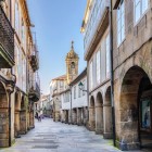 In the historic centre of Santiago de Compostela, Rua Nova leads to the Church of Santa María Salomé, lined with stone arcades and charming medieval streets.