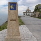 The milestone bearing the Camino de Santiago shell marks the final stretch to Cape Finisterre, where the road meets the Atlantic Ocean.