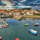 The picturesque harbour of Finisterre, on Galicia's Costa da Morte, welcomes fishing boats and pleasure craft in one of the symbolic destinations beyond Santiago de Compostela.