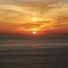 The sun sets over the Atlantic Ocean at Cape Finisterre, painting the sky with light and colours that have inspired pilgrims and travellers for centuries.