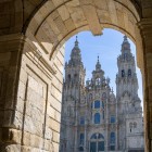 The elegant arch of the Pazo de Raxoi frames the Cathedral of Santiago de Compostela in Praza do Obradoiro, offering an iconic view of the heart of the Camino de Santiago.