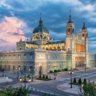Almudena Cathedral dominates central Madrid with its Neoclassical façade, twin towers and dome, blending historicist forms in harmony with the nearby Royal Palace.