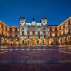As evening falls, the charming Plaza del Mercado Chico lights up before Ávila Town Hall, the city's vibrant heart, just a short walk from the UNESCO-listed medieval walls.