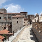 Walking along the medieval walls of Ávila, visitors enjoy beautiful views of the Cathedral of the Saviour, a remarkable Romanesque-Gothic landmark in the UNESCO-listed old town.