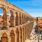 The impressive Roman Aqueduct of Segovia, a UNESCO World Heritage Site, crosses the heart of the city with its elegant granite arches, a masterpiece of ancient Roman engineering.