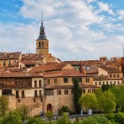 Rising above the terracotta rooftops of the historic centre, the bell tower of one of Segovia's Romanesque churches reflects the city's remarkable medieval heritage.