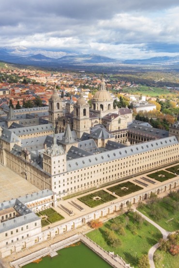 The Royal Monastery of El Escorial rises above the Sierra de Guadarrama with perfect symmetry, reflecting Philip II's vision and the grandeur of the Spanish Renaissance.