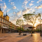 Segovia's Plaza Mayor glows at sunset, where historic arcades, elegant buildings and leafy trees frame one of Castile's most authentic and charming squares.