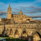 The Roman Bridge over the Tormes River leads to Salamanca's New and Old Cathedrals. Built during the Roman era, it remains one of the city's most iconic historic landmarks.