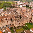 The Royal Monastery of Santa María de Guadalupe dominates the village of Guadalupe with fortified towers, cloisters and structures blending Gothic, Mudéjar, Renaissance and Baroque architecture.