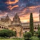 The Cloister of Miracles at Guadalupe Monastery houses a refined Mudéjar pavilion, framed by two levels of arcades and a peaceful, secluded garden.