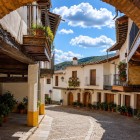 An ancient brick arch opens onto a street in Guadalupe, where medieval houses, wooden balconies and traditional arcades preserve the authentic character of Spain's Extremadura region.