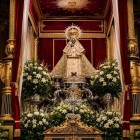 The Black Madonna of Guadalupe graces the High Altar of the Royal Monastery, surrounded by candles, flowers and rich draperies, symbolizing Marian devotion in Extremadura.