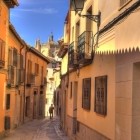 Calle Santa Isabel offers a striking view of Toledo Cathedral: iron balconies and warm-toned houses guide the eye towards the city’s Gothic tower.