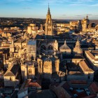 Toledo Cathedral dominates the historic centre with its Gothic tower, chapels and flying buttresses, while the sunset warms the dense maze of city rooftops.