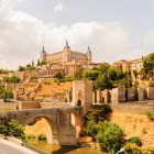 Alcántara Bridge crosses the Tagus below Toledo, dominated by the Alcázar and medieval walls that recount centuries of history in Spain’s remarkable City of Three Cultures.