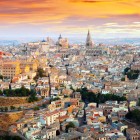 From above, Toledo reveals its medieval heart: terracotta roofs, ancient churches and the Cathedral rise across the historic centre, glowing in the sunset.
