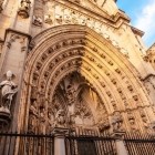 The Puerta del Perdón, central entrance to Toledo Cathedral, reveals Gothic refinement through carved archivolts, statues of saints and sacred scenes gathered in the tympanum.