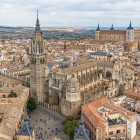 Seen from above, the Primate Cathedral dominates Toledo’s historic centre with its Gothic tower and broad nave, while the Alcázar rises beyond the Castilian rooftops.