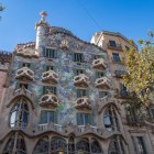 Casa Batlló amazes on Passeig de Gràcia with Gaudí’s undulating façade, enlivened by mosaics, mask-like balconies and a roof recalling the back of a winged dragon.