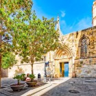 Plaça de Sant Iu preserves the oldest entrance to Barcelona Cathedral: opened in 1298, the pointed-arch doorway served as its main access for five centuries in the heart of the Gothic Quarter.