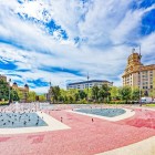 Plaça de Catalunya opens the heart of Barcelona with fountains, gardens and geometric paving, surrounded by elegant buildings between the historic centre and the Eixample.