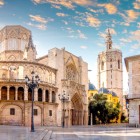 Overlooking Plaza de la Almoina, Valencia Cathedral reveals the Romanesque Puerta del Palau and El Miguelete; dedicated to the Assumption by James I, it has been a minor basilica since 1886.