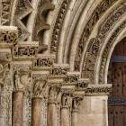The Porta del Palau, the Romanesque entrance to Valencia Cathedral, fascinates with sculpted archivolts and historiated capitals preserving 13th-century symbols and figures.