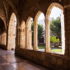 The Gothic cloister of Santander Cathedral features elegant pointed arches and sturdy stone columns opening onto a peaceful garden in the heart of the city.