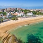 Aerial view of El Sardinero Beach in Santander, a wide golden shoreline washed by the turquoise waters of the Cantabrian Sea and framed by an elegant promenade.