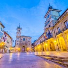 From a side perspective, Plaza de la Constitución leads the eye between the Town Hall arcades and San Isidoro’s tower, through the civic and religious heart of historic Oviedo.