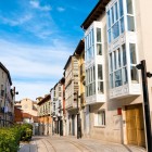 Calle de la Puebla, a pedestrian street in Burgos’ historic centre. Its traditional glazed galleries lead the eye towards the Gothic Church of San Lesmes, overlooking Plaza de San Juan.