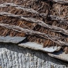 On palloza roofs, bundles of rye straw are layered and tied to a wooden frame: the teitado technique creates a thick, insulating and waterproof covering.
