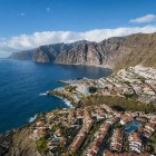 The imposing Los Gigantes cliffs rise above the Atlantic, overlooking the marina and the houses of Puerto de Santiago, nestled along Tenerife’s spectacular western coast.