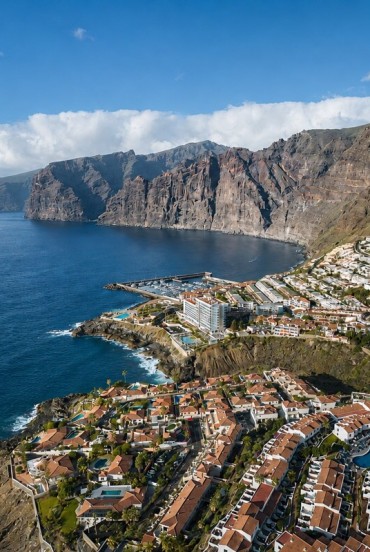 The imposing Los Gigantes cliffs rise above the Atlantic, overlooking the marina and the houses of Puerto de Santiago, nestled along Tenerife’s spectacular western coast.