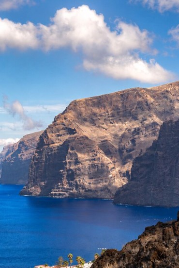 The imposing Los Gigantes cliffs rise above the Atlantic, surrounded by volcanic rocks, deep-blue waters and the wild scenery of Tenerife’s western coast.
